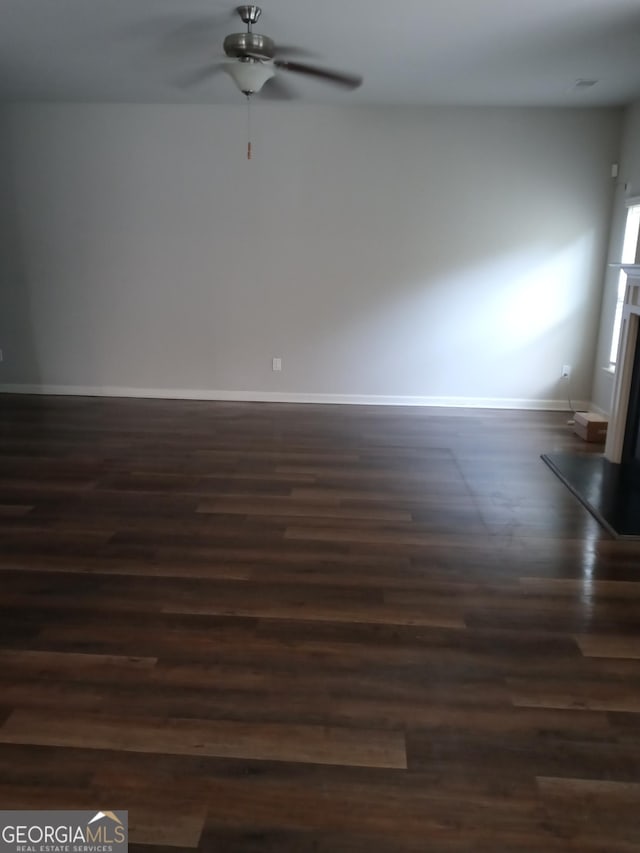 spare room featuring ceiling fan and dark hardwood / wood-style flooring