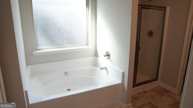 full bath featuring a stall shower, tile patterned flooring, and a bath