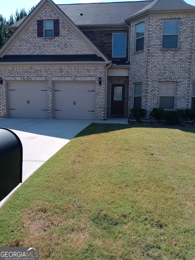 view of front of house with a garage and a front lawn