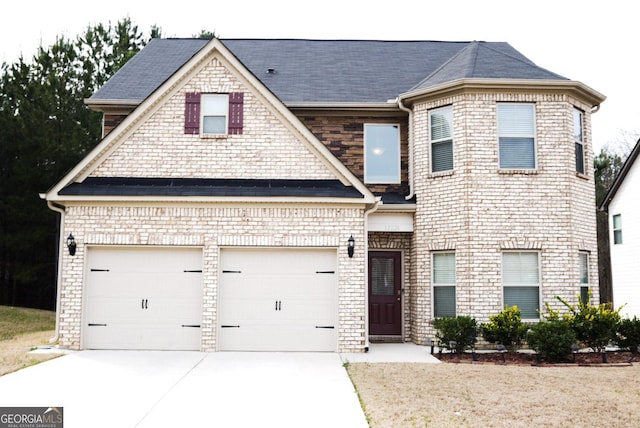 view of front of home with brick siding, concrete driveway, and an attached garage