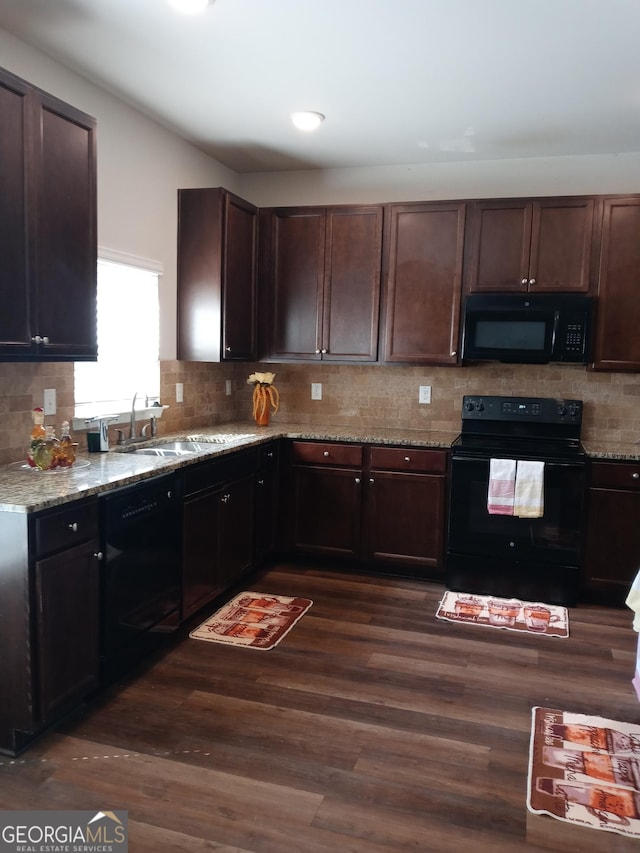 kitchen featuring sink, dark hardwood / wood-style flooring, dark brown cabinetry, and black appliances