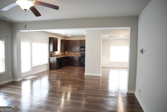 unfurnished living room with a ceiling fan, dark wood-style floors, and baseboards