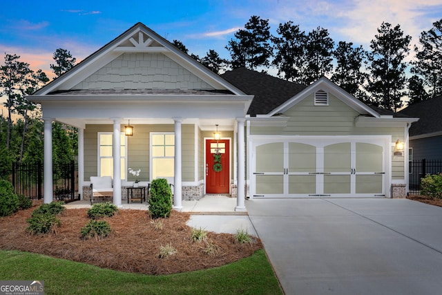 craftsman-style home with covered porch and a garage