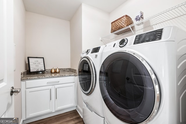 laundry area with dark hardwood / wood-style floors and washer and clothes dryer