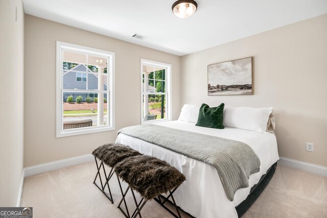 bedroom with light colored carpet