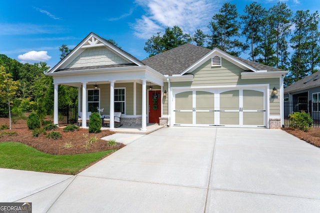 craftsman inspired home featuring a porch and a garage