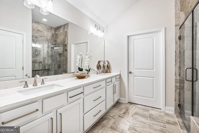 bathroom featuring vanity, lofted ceiling, and walk in shower