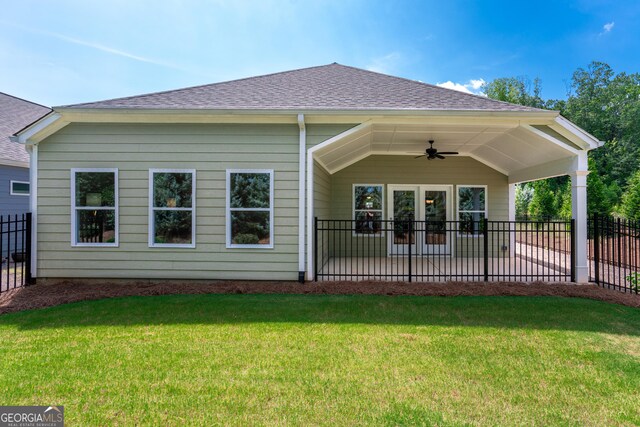 back of property with a lawn, a patio area, and ceiling fan