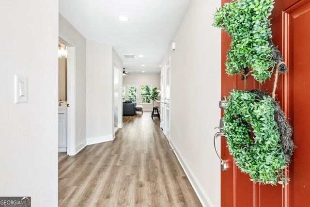 hallway with light hardwood / wood-style flooring