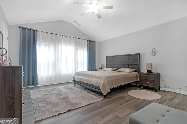 bedroom with ceiling fan, vaulted ceiling, and hardwood / wood-style flooring