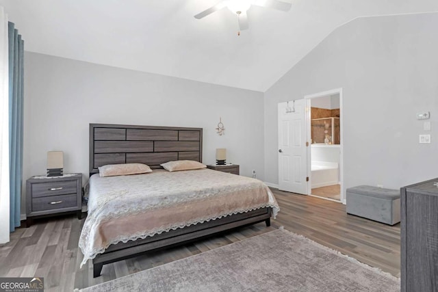 bedroom featuring vaulted ceiling, hardwood / wood-style flooring, ensuite bath, and ceiling fan