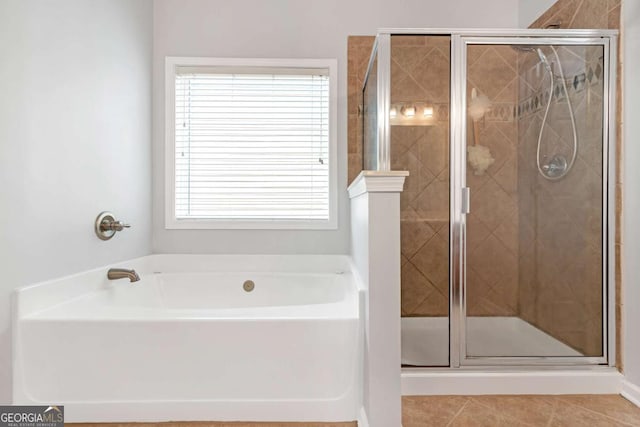 bathroom featuring tile patterned floors, separate shower and tub, and a wealth of natural light