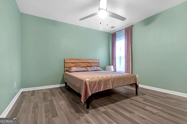 bedroom with ceiling fan and hardwood / wood-style floors