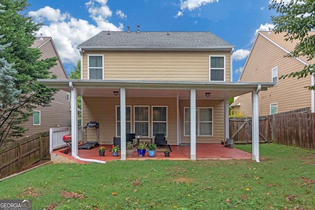 rear view of house featuring a yard and a patio area