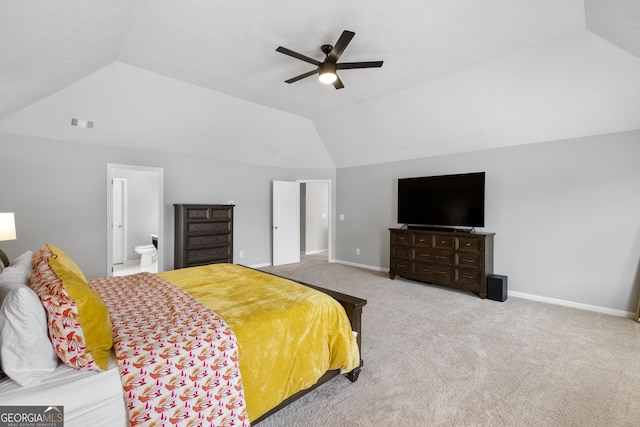 bedroom with carpet, ensuite bathroom, vaulted ceiling, and ceiling fan