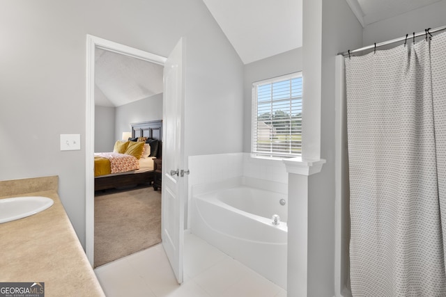 bathroom with a bathtub, vanity, and lofted ceiling