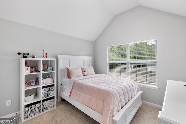 bedroom with multiple windows, light carpet, and vaulted ceiling