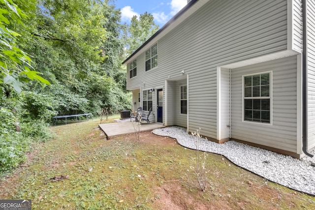 view of yard featuring cooling unit, a trampoline, and a patio