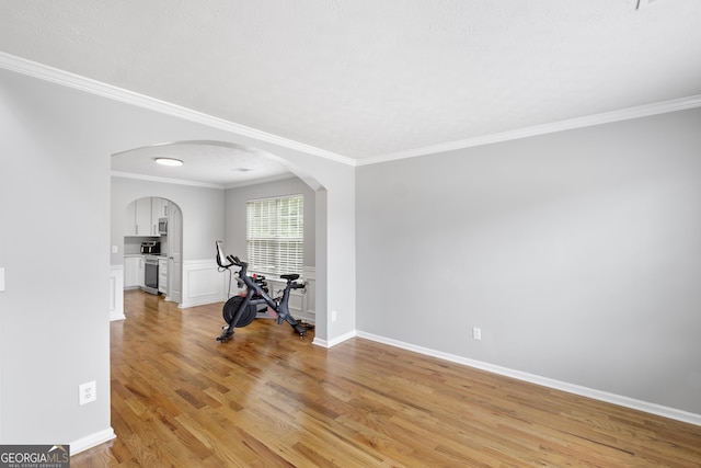 unfurnished room featuring light wood-type flooring and crown molding