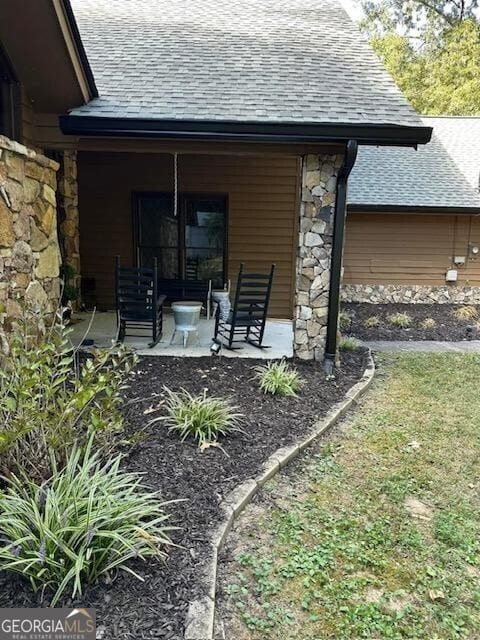 rear view of property with a porch