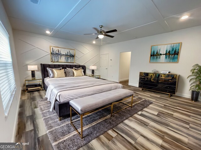 bedroom featuring ceiling fan, hardwood / wood-style floors, and coffered ceiling