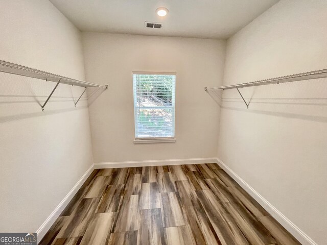 walk in closet featuring dark hardwood / wood-style flooring