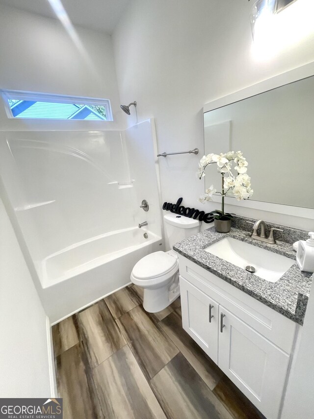 full bathroom featuring shower / bath combination, vanity, wood-type flooring, and toilet