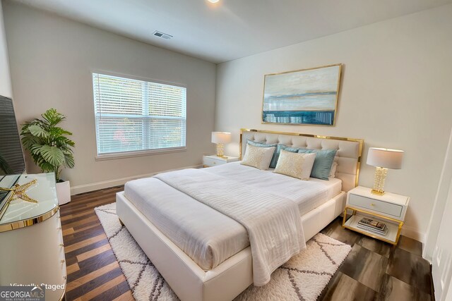 bedroom featuring dark hardwood / wood-style flooring