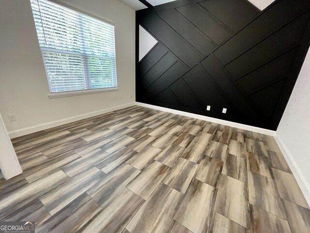 unfurnished room featuring hardwood / wood-style floors