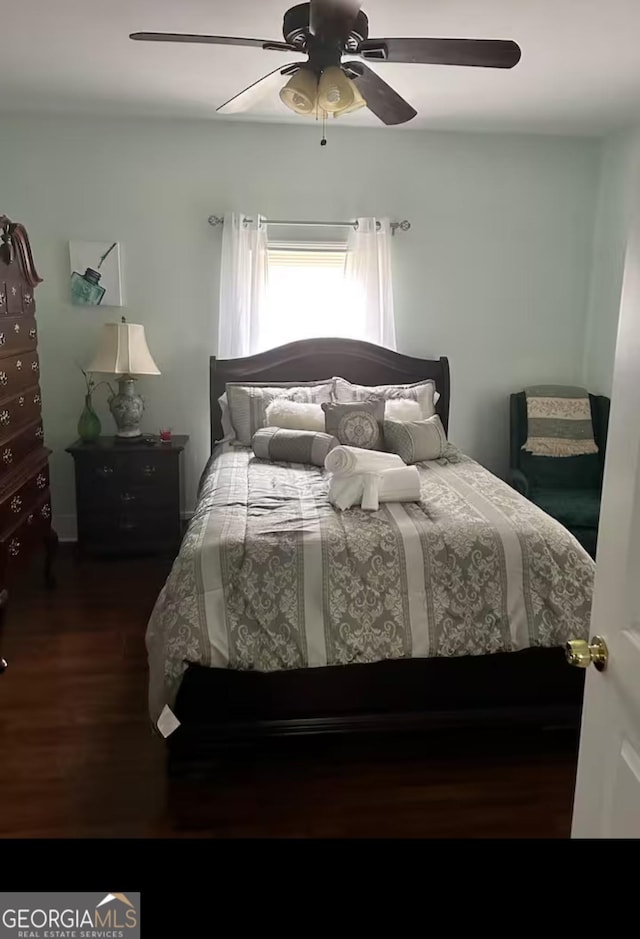 bedroom featuring dark hardwood / wood-style floors and ceiling fan