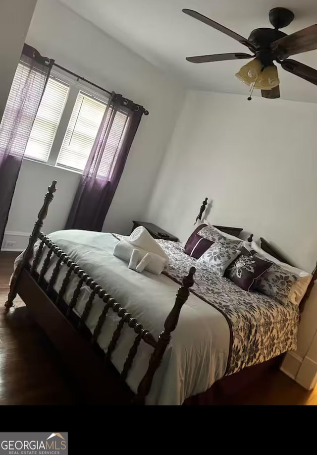 bedroom featuring wood-type flooring and ceiling fan