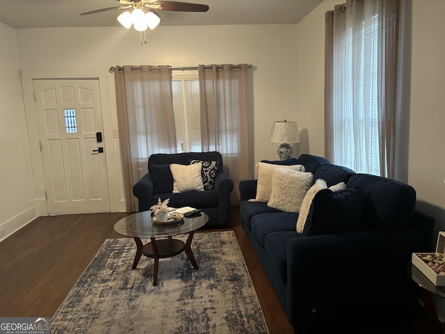 living room featuring ceiling fan and dark hardwood / wood-style flooring