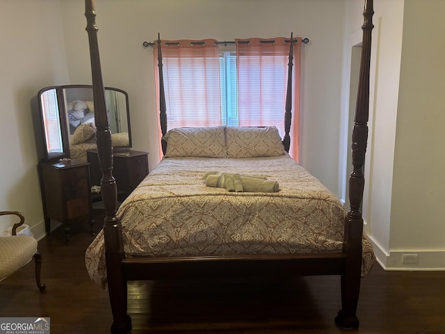 bedroom with dark wood-type flooring