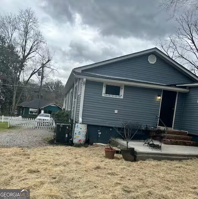 back of house featuring a patio area and a yard