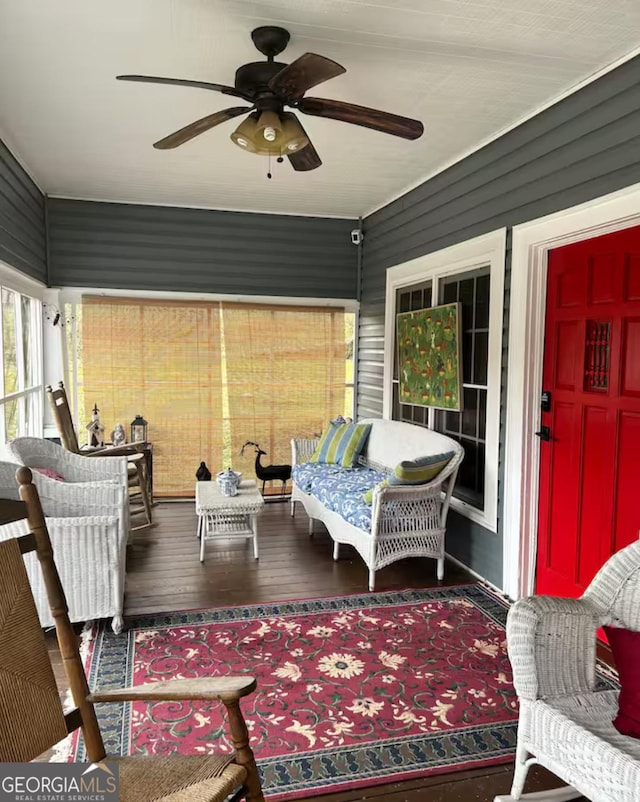 interior space with ceiling fan