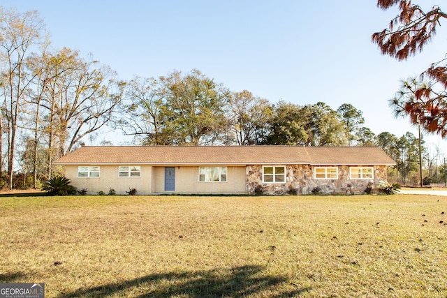 ranch-style home with a front lawn