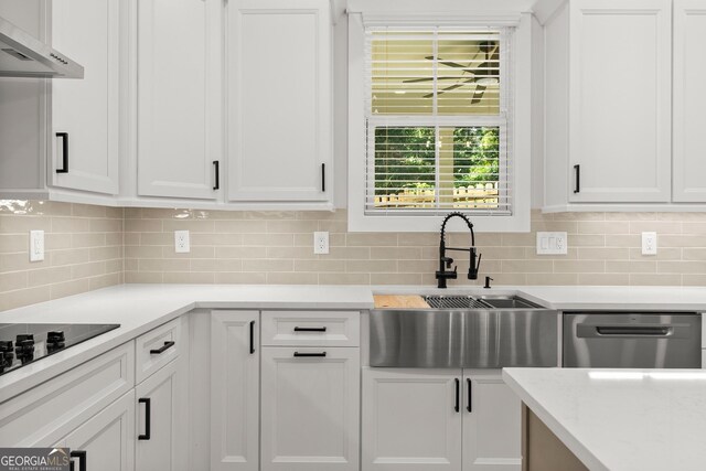 kitchen with white cabinets, dishwasher, decorative backsplash, and sink