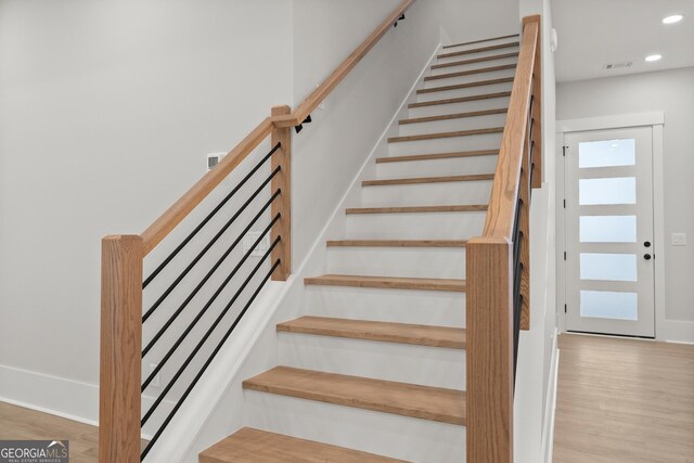 stairs with wood-type flooring