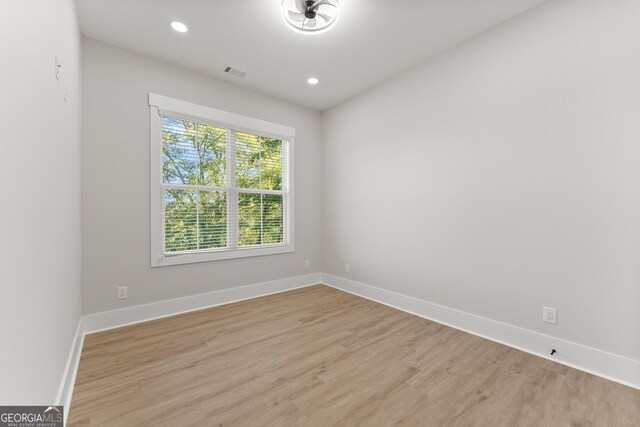 unfurnished room with light hardwood / wood-style floors