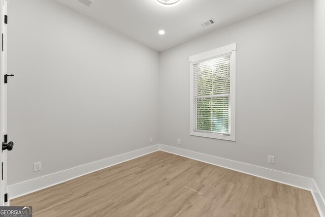 spare room featuring light hardwood / wood-style floors