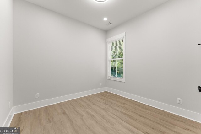 spare room with light wood-type flooring