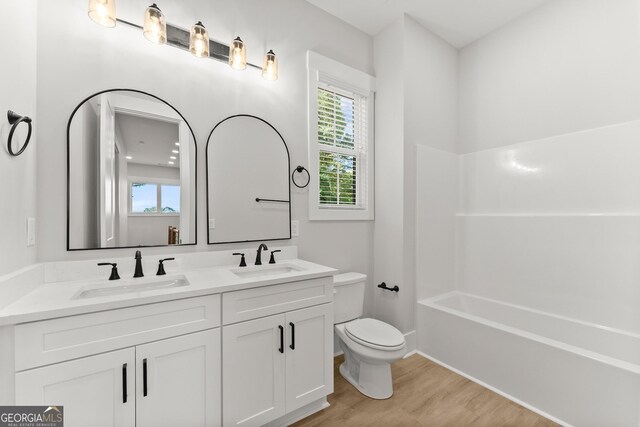 bathroom featuring hardwood / wood-style floors, vanity, and toilet