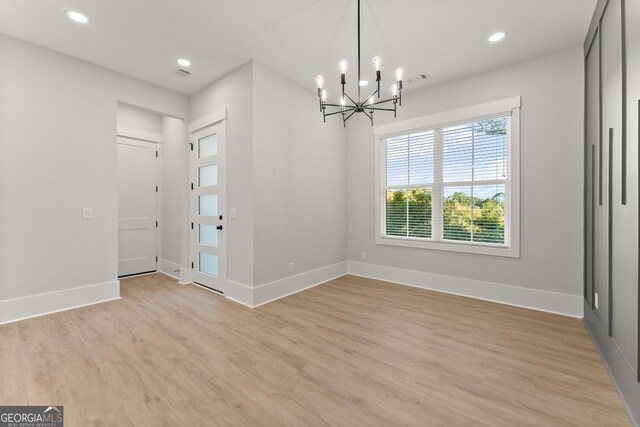 foyer featuring a chandelier and light hardwood / wood-style floors