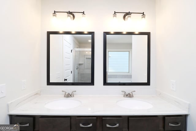 bathroom with vanity and a shower with door