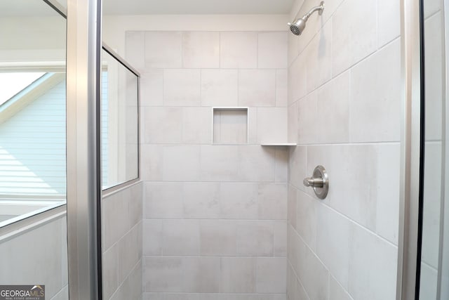 bathroom with a shower with door