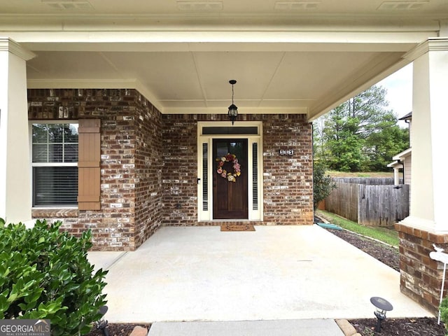 view of exterior entry with covered porch