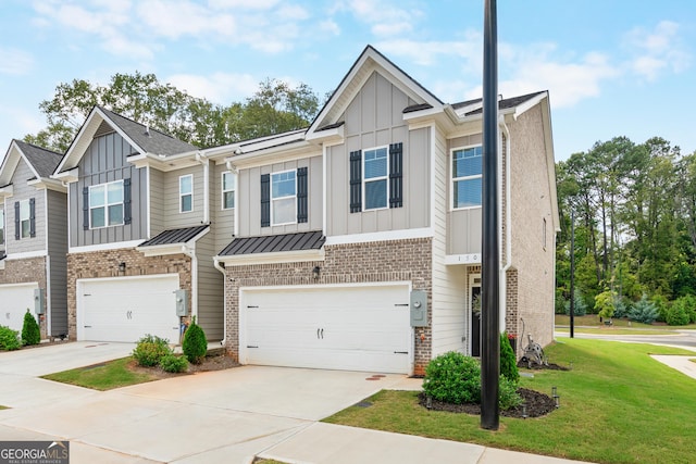 view of property with a front yard and a garage