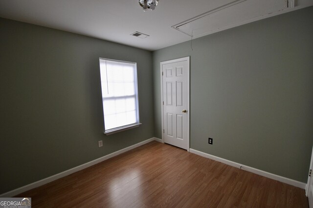 unfurnished room featuring hardwood / wood-style floors