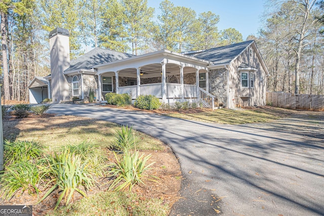 view of front of house with ceiling fan and a porch