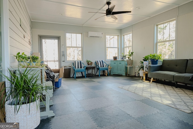 sunroom with a wall mounted air conditioner and ceiling fan